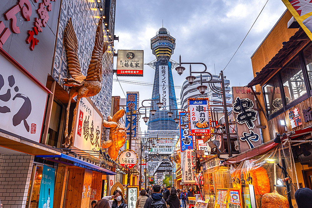 Shinsekai District and Tsutenkaku Tower in the evening with colorful neon lights of restaurants, Osaka, Honshu, Japan, Asia