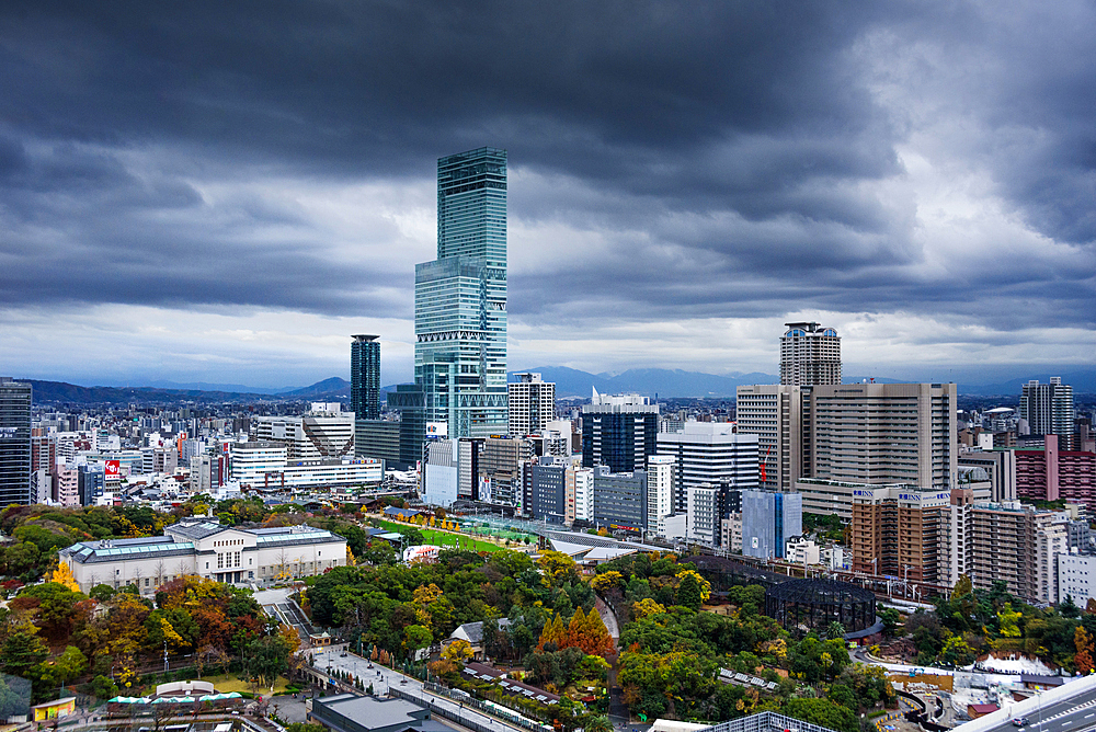 View of the city skyline with a dramatic sky, looking at Harukas 300 Observatory and Park of the Castle, Osaka, Honshu, Japan, Asia