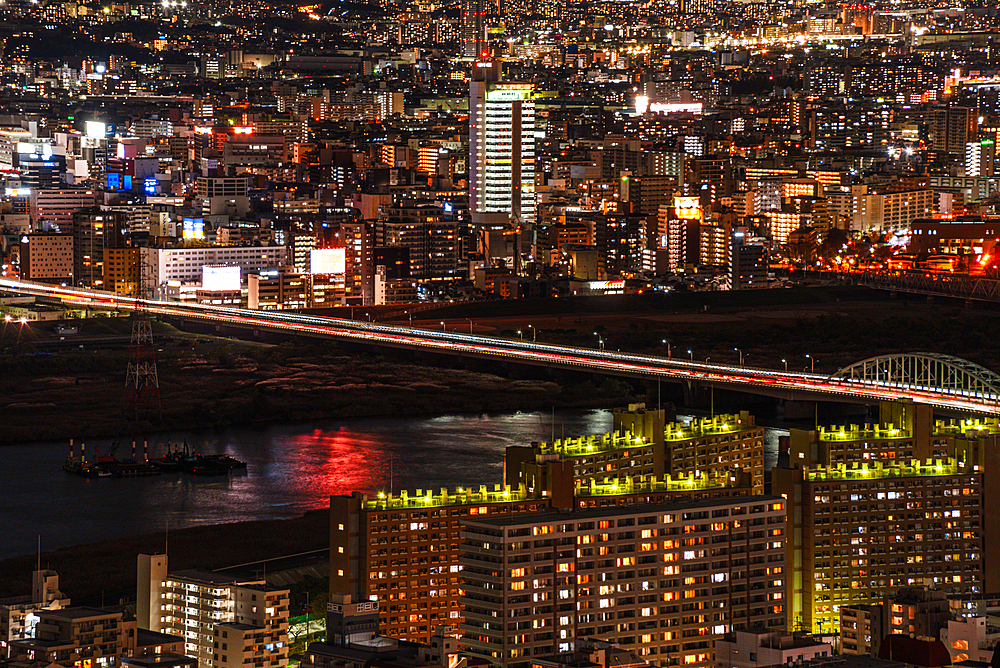 Night Skyline of Osaka, Japan. Highway and Train bridges crossing the Yodo River. Juso Bridge aerial view