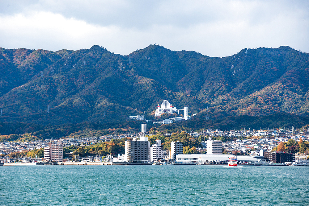 City at the foot of a mountain at the inland sea, Miyajima, Hiroshima Prefecture, Honshu, Japan, Asia