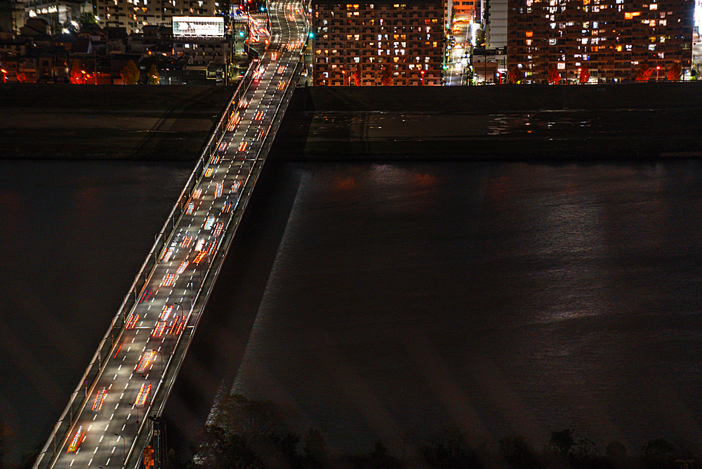 Midnight night skyline of Osaka, Japan. Close up details. Traffic on bridges crossing the yodo River