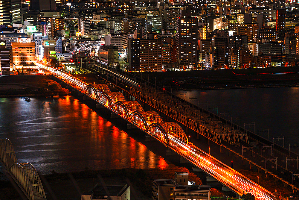 Midnight night skyline of Osaka, Japan. Close up details. Traffic on bridges crossing the yodo River