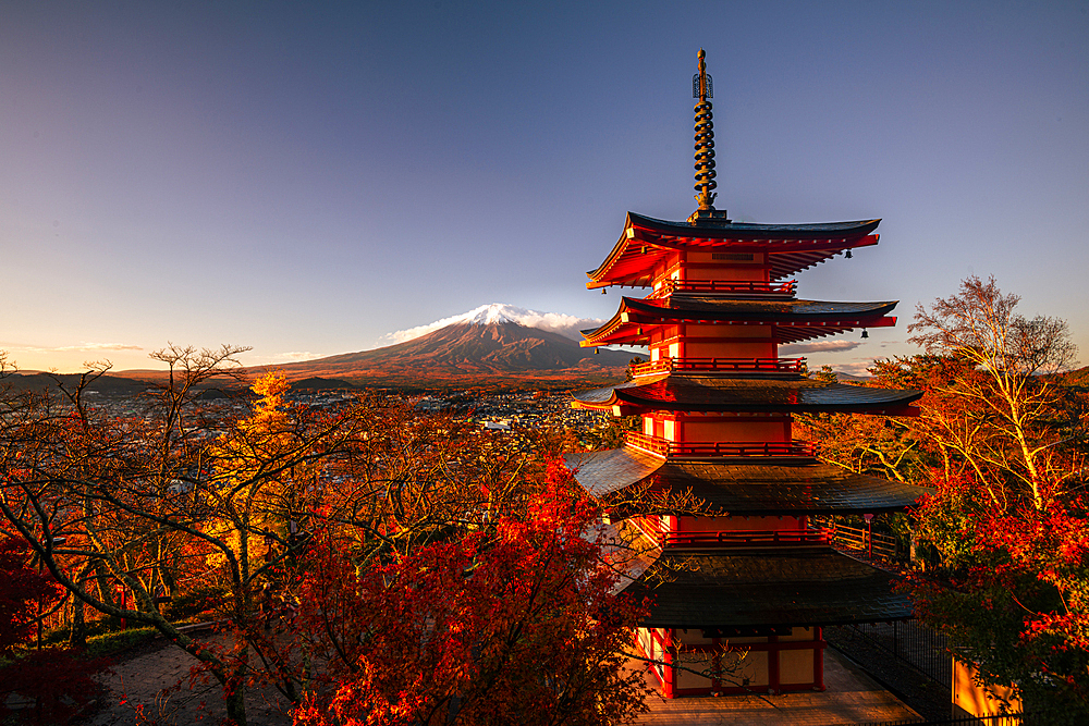 Vibrant sunrise at Five-storey pagoda, Chureito Pagoda, overlooking Fujiyoshida City and Mount Fuji Volcano. Japan. Autumn in Japa