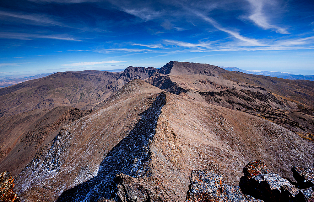 View from the summit of Pico del Veleta, Sierra Nevada. Faults leading to Mulhacén. Blue sky visibility unitl the coast. Granada, Spain