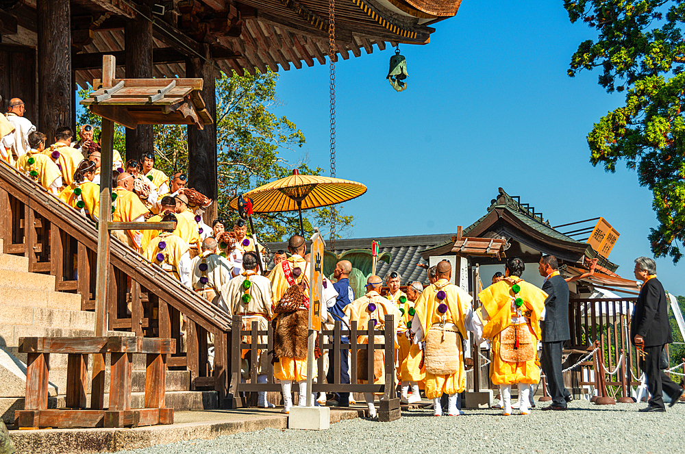 Buddhist monks in yellow robes at the temple, Yoshino autumn celebrations, festival to pray for a good harvest at the Tenmangu of Kinpusen-ji temple, Yoshino, Honshu, Japan, Asia