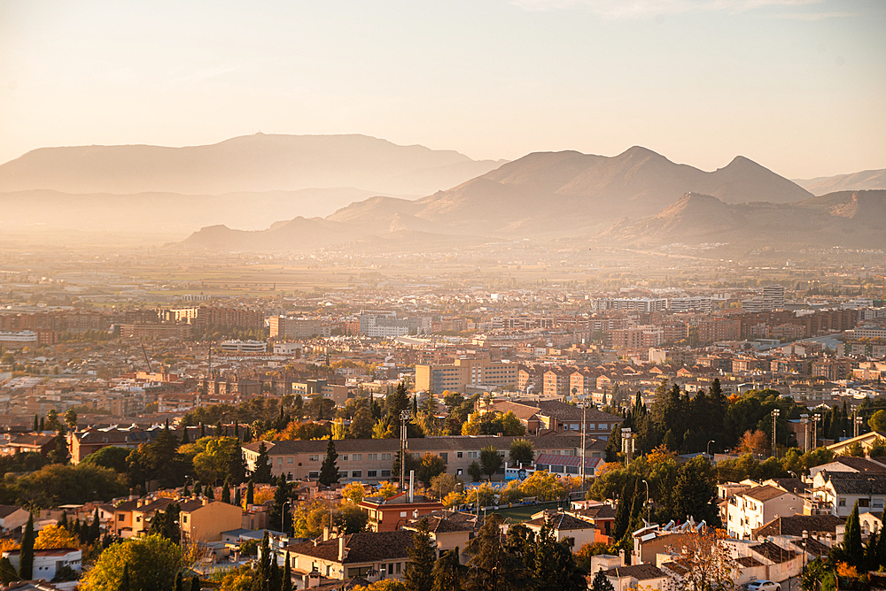 Sunset above Granada looking north to Cartuja with the mountains of Parque Natural Sierra de Huetor, Granada, Andalucia, Spain