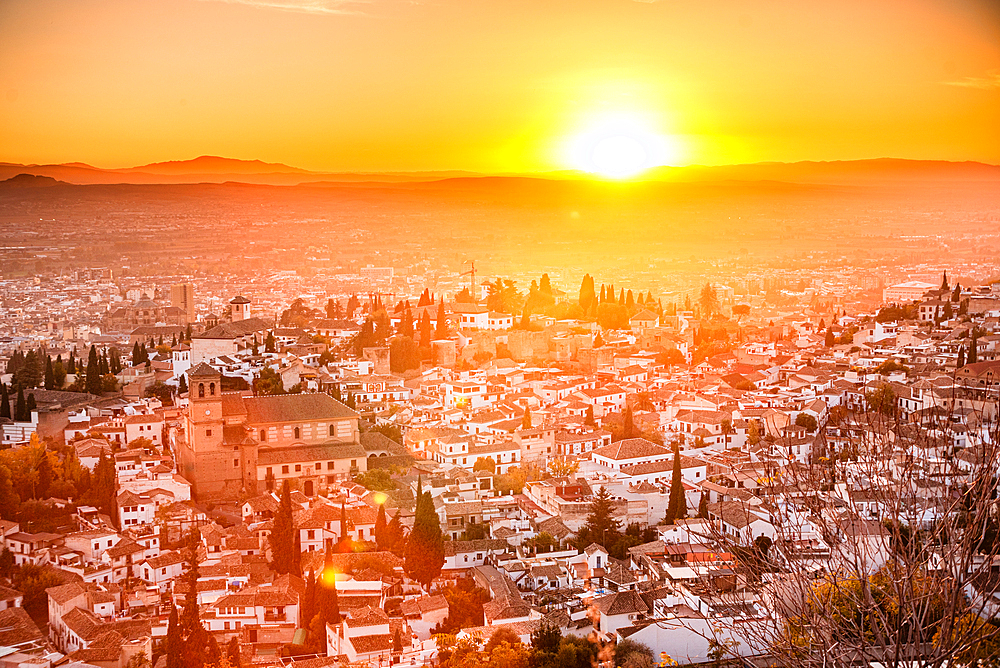 Vibrant red and orange sunset over the Albaicin, Granada, Andalucia, Spai. Offerin a beautiful panoramic view of this UNESCO world heritage