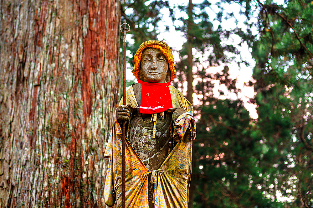 Dressed statue in deep forest of Koyasan, Buddhist cemetery of Oku-no-in, Koyasan (Koya-san), Kansai, Honshu, Japan