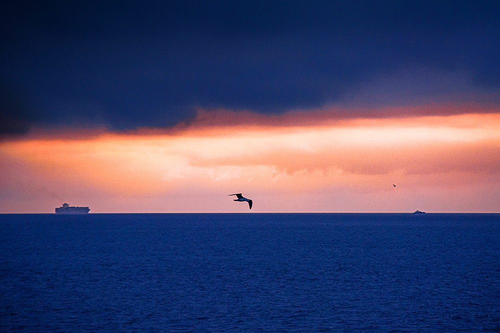 Blue hour sunrise on the Strait of Gibraltar crossing the ocean from Spain to Morocco