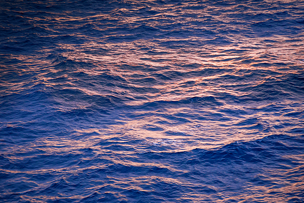 Blue hour sunrise on the Strait of Gibraltar crossing the ocean from Spain to Morocco