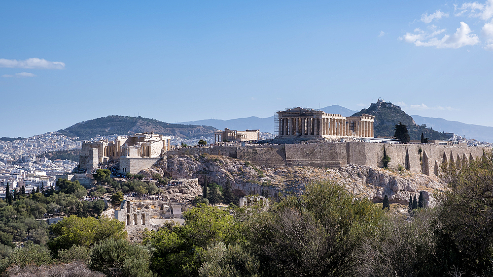 View of the Acropolis of Athens from Mouseion Hill, located to the southwest. The Acropolis, an ancient citadel perched on a rocky outcrop above the city, contains the remains of several significant ancient buildings, including the Parthenon.