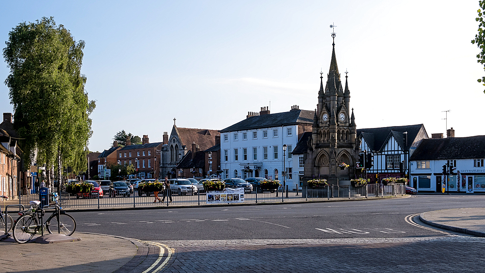 Scenic view of the Shakespeare Memorial Fountain in Stratford-upon-Avon, England, on a sunny day. This ornate fountain, erected in 1887, commemorates the 300th anniversary of Shakespeare's birth, adding historical charm to the heart of his birthplace.