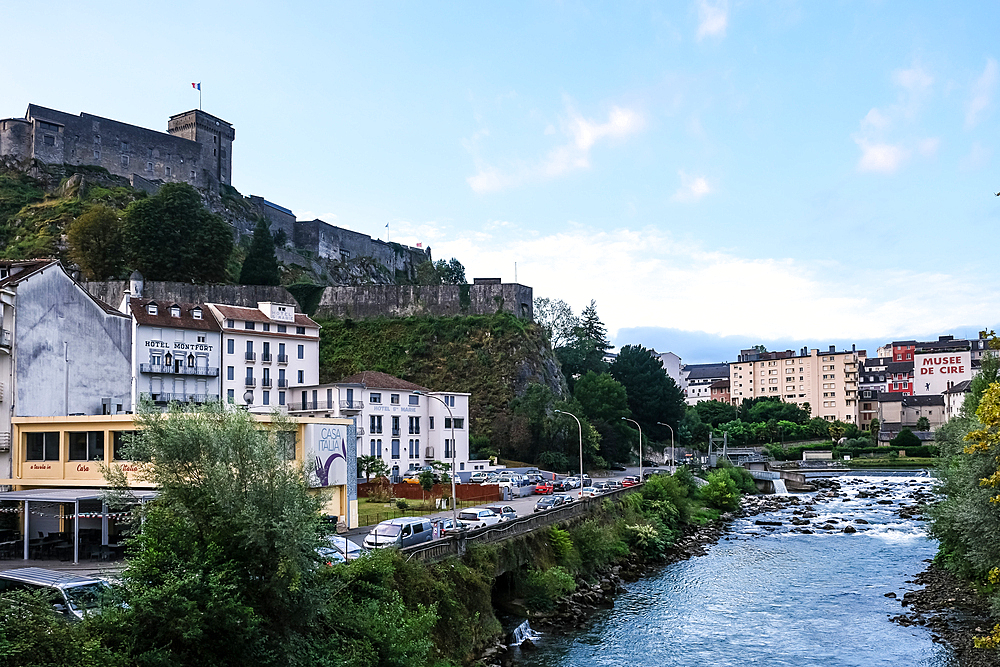 Urban landscape of Lourdes, market town in the Pyrenees, Chateau Fort in background, Lourdes, Hautes-Pyrenees, Occitanie, France