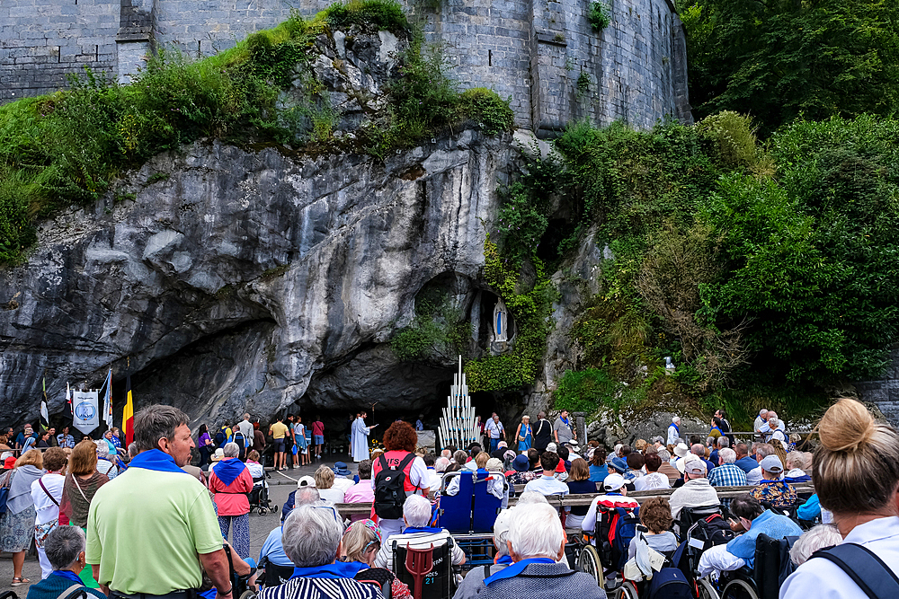 View of the Massabielle grotto at the Sanctuary of Our Lady of Lourdes, a Catholic shrine and pilgrimage site in Lourdes, Hautes-Pyrenees, France