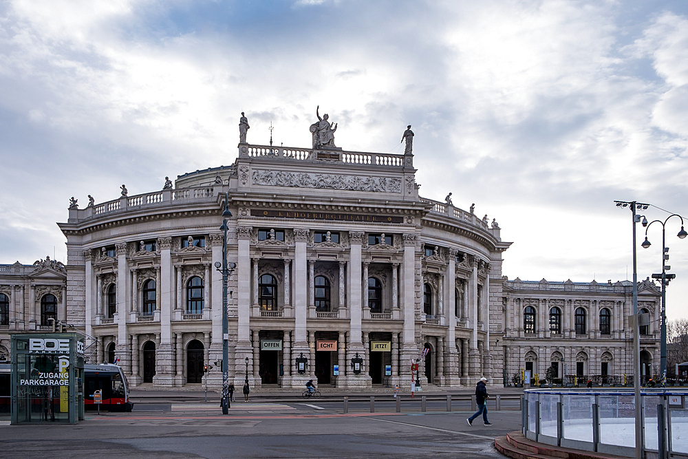 Vienna, Austria – View of the Burgtheater's grand Renaissance Revival facade on Ringstrasse, showcasing its symmetrical design with arched windows, sculpted loggia, and ornate roof balustrade overlooking Volksgarten.