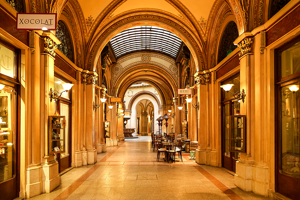 Vienna, Austria – View of the Ferstel Passage interior, the 19th-century covered shopping arcade with ornate ironwork, glass vaulted ceilings, and Renaissance Revival details connecting Herrengasse and Strauchgasse.