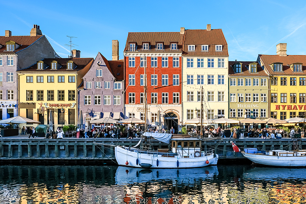 Copenhagen, Denmark – View of Nyhavn (New Haven), a 17th-century waterfront and canal lined with colorful historic townhouses, cafes, and wooden ships.
