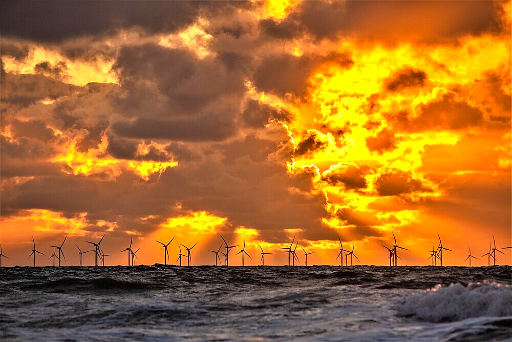 Sunset view from Walney Island across the Irish Sea towards the distant Walney Offshore Wind Farm, Cumbrian Coast, Cumbria, England, United Kingdom, Europe