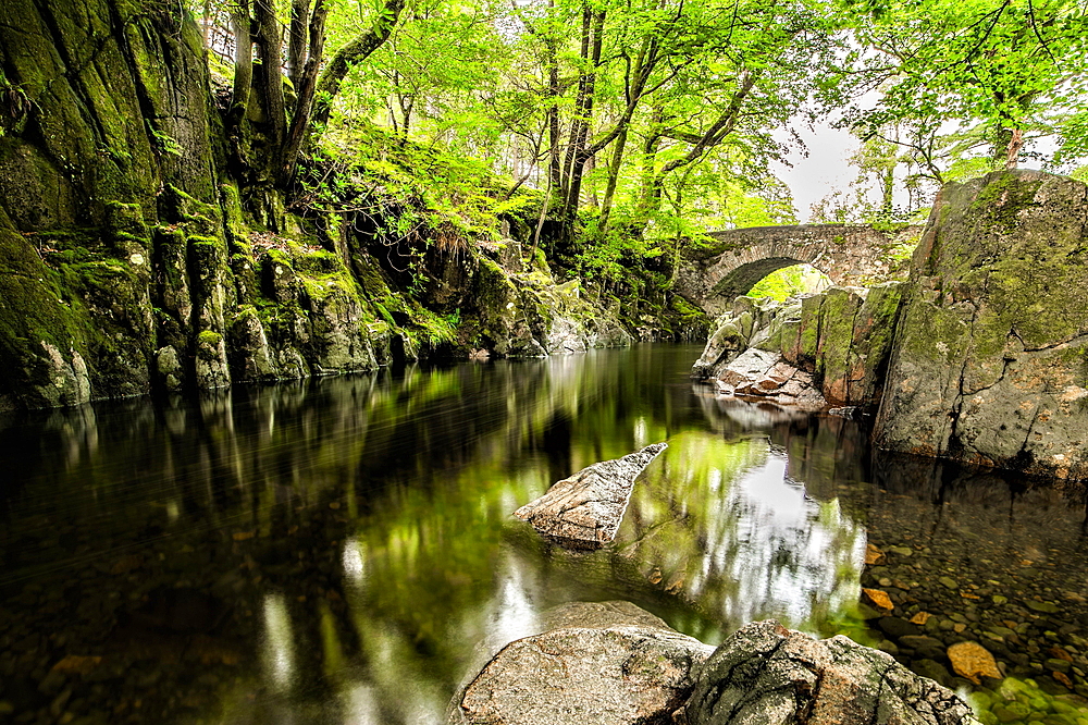 Overcast day in the Eskdale Valley with calm and cold waters from Trough House Bridge and the stunning River Esk, Lake District National Park, UNESCO World Heritage Site, Cumbria, England, United Kingdom, Europe