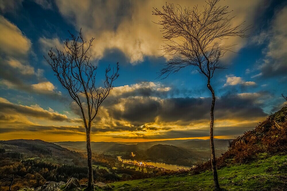 Sunset view from Gummers How in the Lake District, UNESCO World Heritage Site, across Windermere towards the distant Cumbrian Coast and Furness Peninsula, Cumbria, England, United Kingdom, Europe