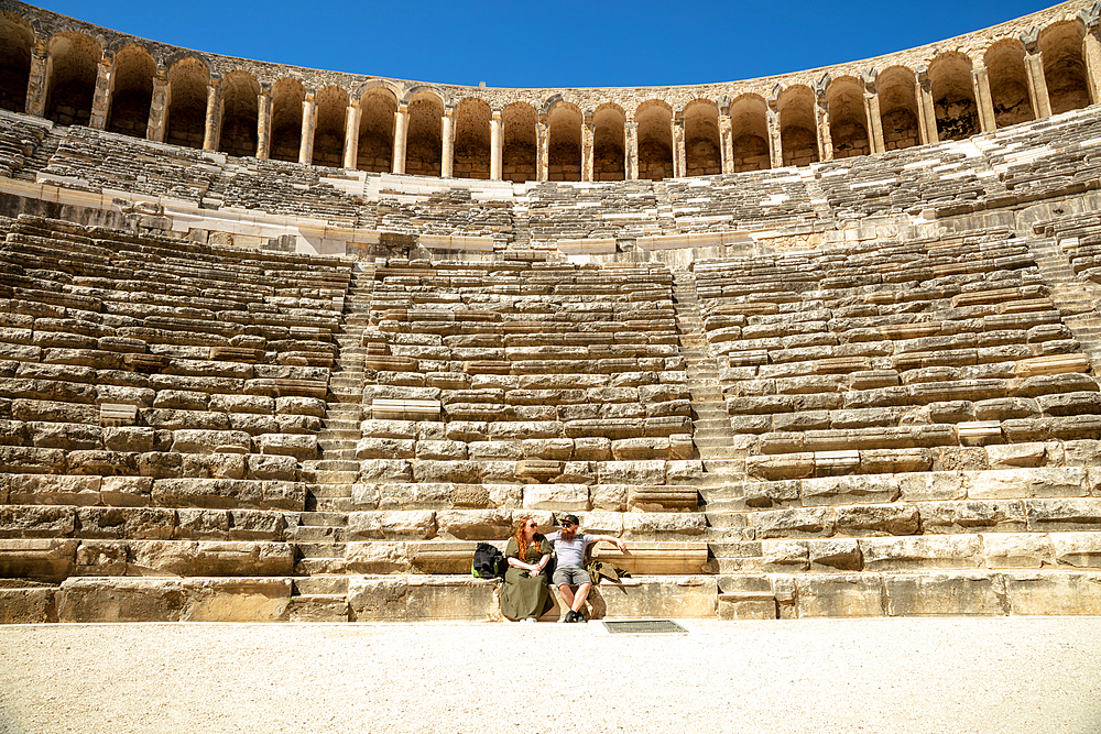 Resting couple, view from a middle of an ancient Amphitheatre, Aspendos, Antalya Province, Turkey, Asia Minor, Eurasia