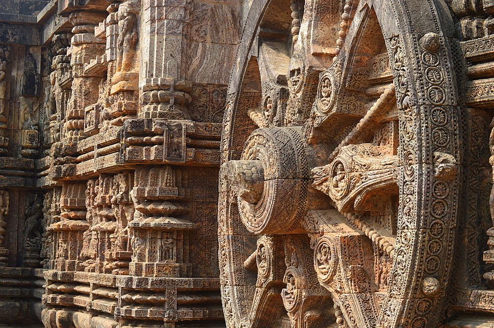 Konark 13th-century Sun Temple (Surya Deula) designed to represent chariot of Hindu Sun God with 12 huge carved stone wheels and 7 stone horses around its base UNESCO World heritage site.Images of stone chariot wheels.