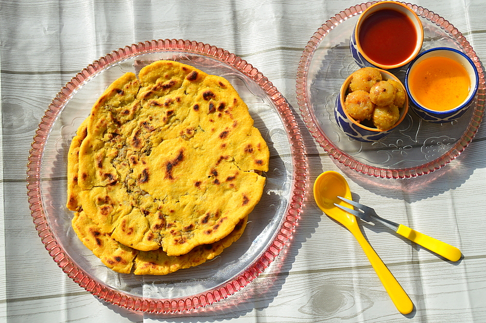 Arbi (colocasia) ki kachori traditional Himachali dish,maize flour roti stuffed with messed arbi served with desi ghee, curd and chutney.