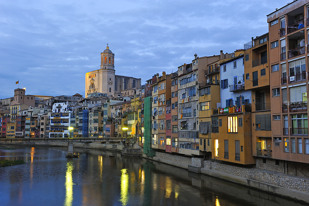 Front of the houses by the Onyar River at dusk, with the bell tower of the Cathedral in the background, Girona, Catalonia, Spain, Europe