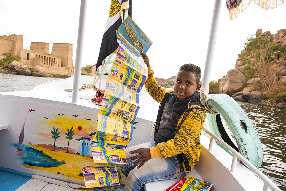 Young guide-card salesman on board a tourist boat heading towards the Temple of Isis, Temple of Philae, Agilkia Island, Aswan, Egypt, North Africa, Africa