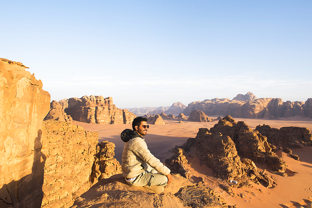 Man enjoying sunset in Wadi Rum desert, UNESCO World Heritage Site, Jordan, Middle East