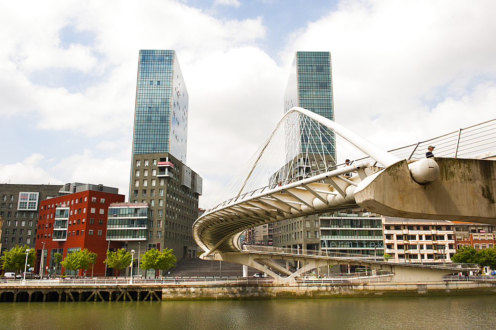 The Zubizuri, tied arch footbridge across the Nervion River, designed by architect Santiago Calatrava, with the Isozaki Atea twin towers designed by Japanese architect Arata Isozaki in the background, Bilbao, province of Biscay, Basque Country, Spain,Europe