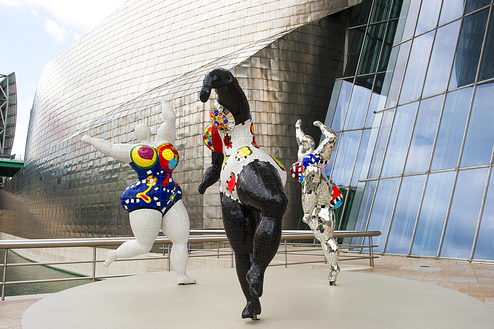 temporary exhibition of 'Nanas' by the French artist Niki de Saint Phalle (1930-2002) at the Guggenheim Museum designed by architect Frank Gehry, Bilbao, province of Biscay, Basque Country, Spain,Europe