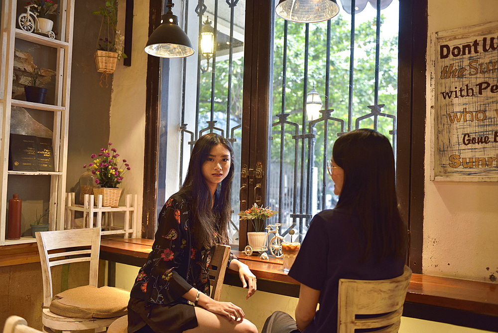 Young girl at Hero Coffee cafe, Kepodang Street, Old Town of Semarang, Java island, Indonesia, Southeast Asia, Asia