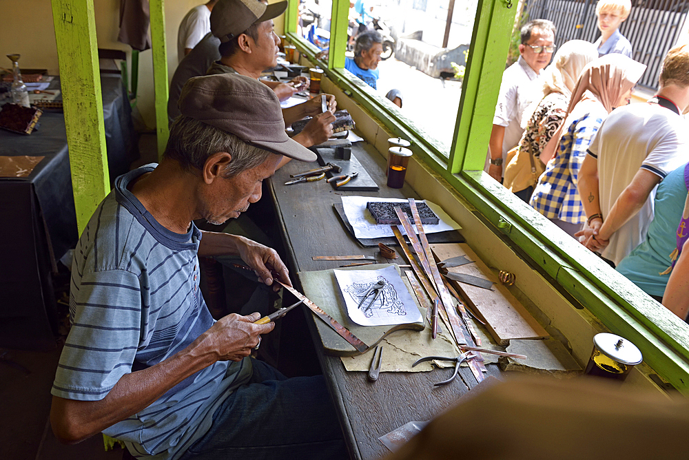 workshop of copper plate stamps (cap) used to apply wax-resist to make pattern before dyeing in batik process, Sondakan district, Solo (Surakarta), Java island, Indonesia, Southeast Asia