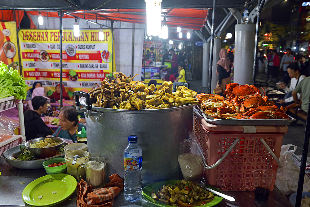 Open-air street side restaurant (lesehan) by night on Malioboro Street, major shopping street in Yogyakarta, Java island, Indonesia, Southeast Asia, Asia