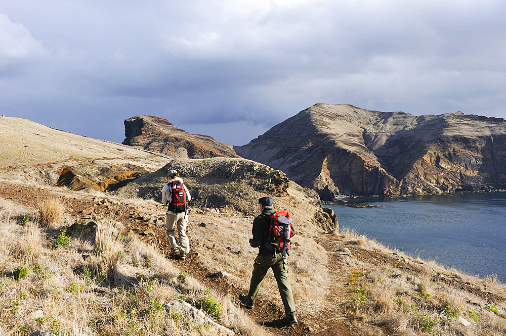 Hikers along Abra Bay, Sao Lourenco peninsula, Madeira island, Atlantic Ocean, Portugal