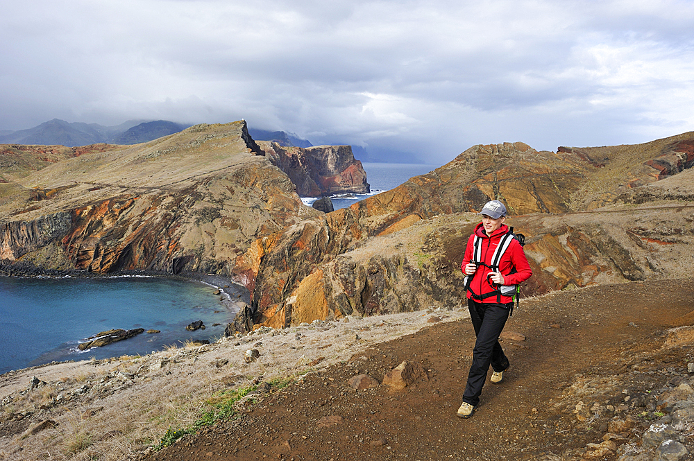 young woman walking along the Abra bay,Sao Lourenco peninsula,Madeira island,Atlantic Ocean,Portugal