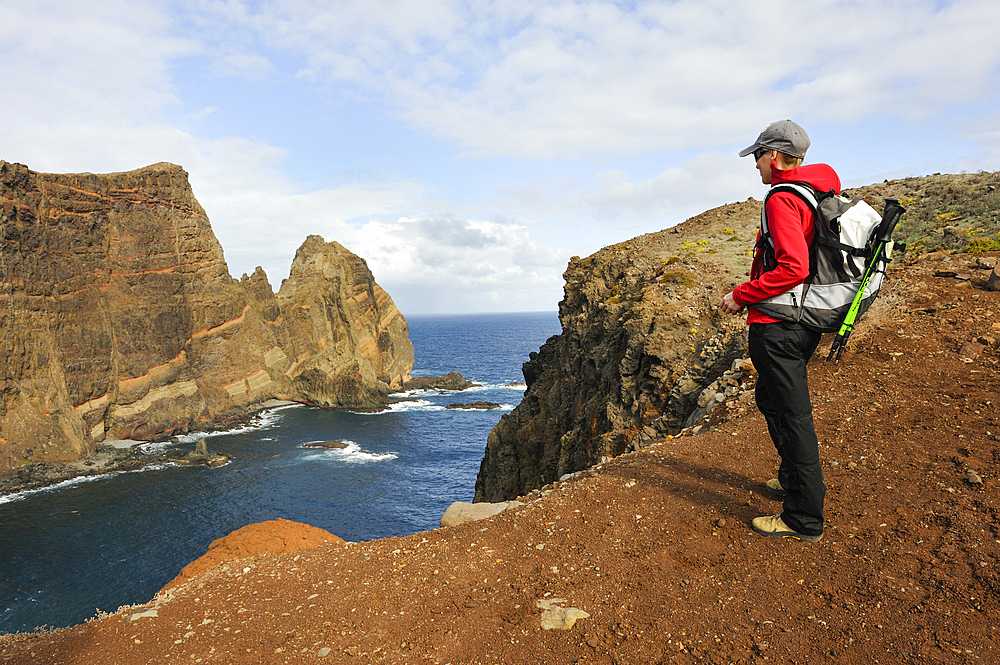 Young woman walking on Cevada islet, Sao Lourenco peninsula, Madeira island, Atlantic Ocean, Portugal