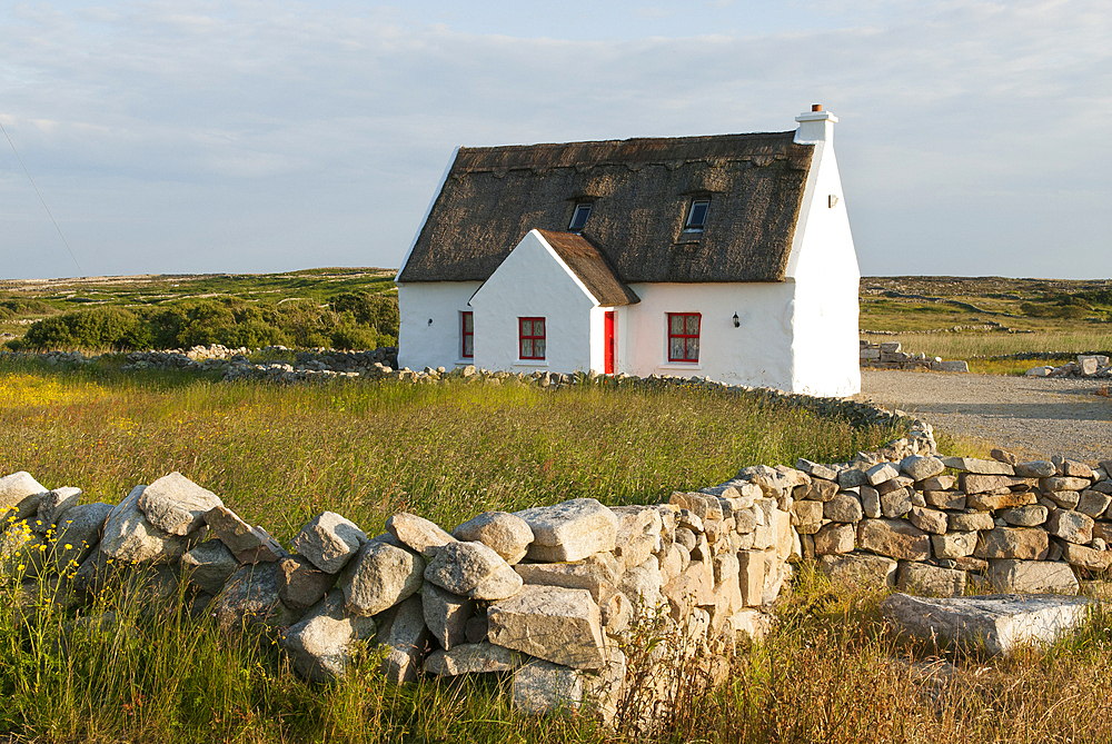 Cottage and low wall, Connemara, County Galway, Connacht, Republic of Ireland