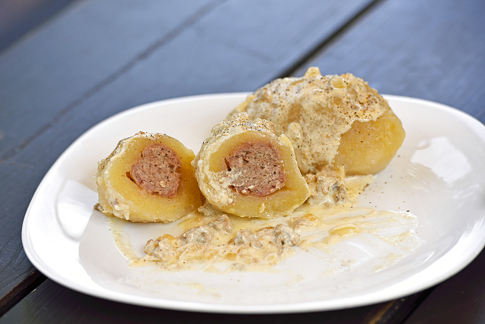 Cepelinai, national dish, potatoes stuffed with ground meat, served at Romnesa bakery-restaurant at Strigailiskis, Ignalina district, Aukstaitija National Park, Lithuania, Europe