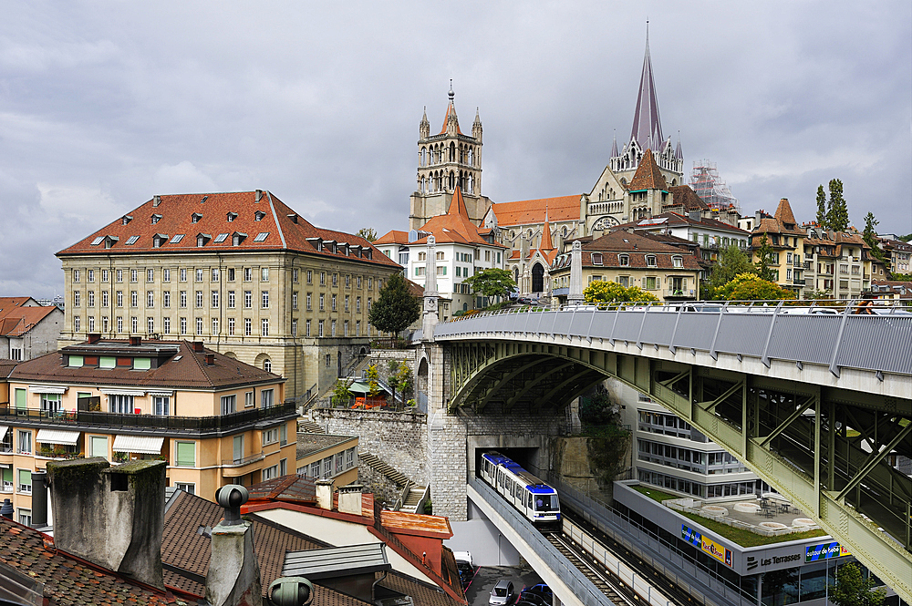 Metro railway on St-Martin bridge under the Bessieres bridge with Cathedral of Notre Dame in background, Lausanne, Canton of Vaud, Switzerland