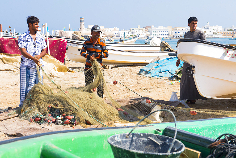 Fishermen on the beach in front of the Al Ayjah village, Sur, port-city, capital of Ash Sharqiyah Region, Sultanate of Oman, Arabian Peninsula