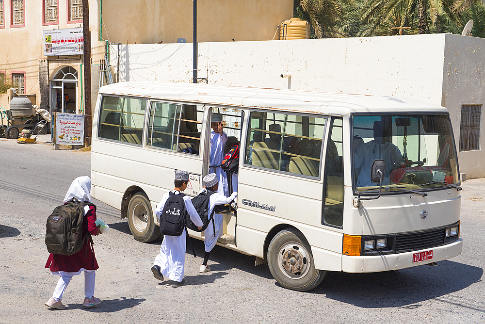 Schoolchildren taking the school bus, Birkat Al Mouz in the Al Dakhliya region at the foothills of Jebel Akhdar, Sultanate of Oman, Arabian Peninsula, Middle East