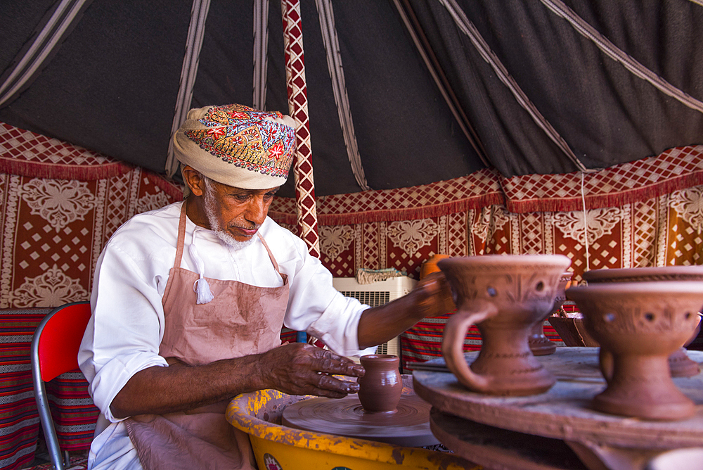 Salih potter, making a demonstration of his craft in the enclosure of the Fort of Nizwa, Ad Dakhiliyah Region, Sultanate of Oman, Arabian Peninsula, Middle East