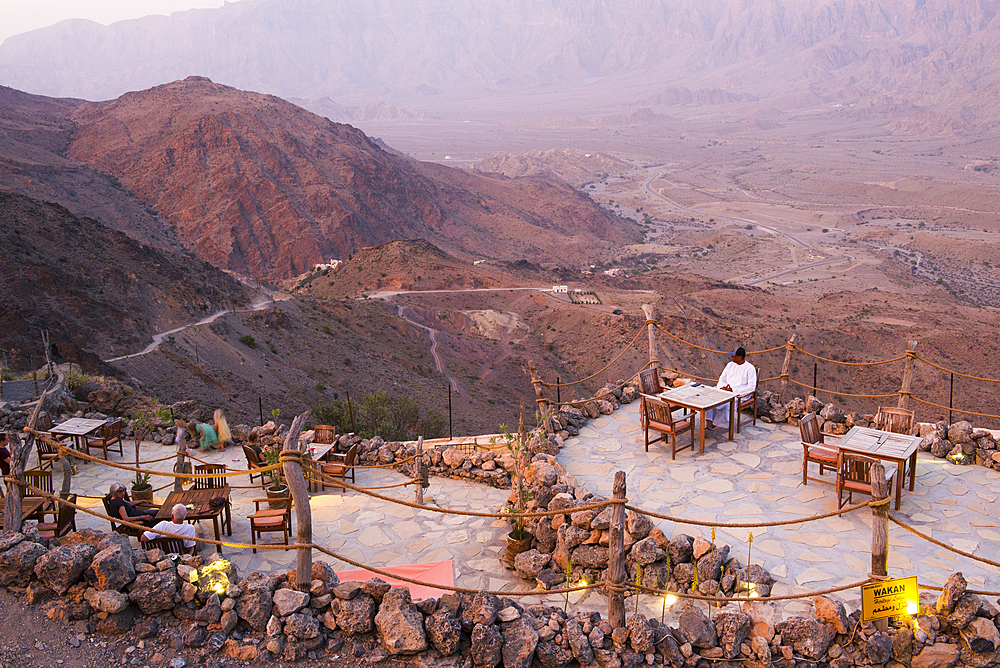 Terrace of Sama Wakan Heritage hotel and guesthouse at dusk, Wakan village in the Western Hajar Mountains, South Batinah Governorate in the border with Al Dakhiliyah Governorate through Al Hajar mountain range. Sultanate of Oman, Arabian Peninsula, Middle