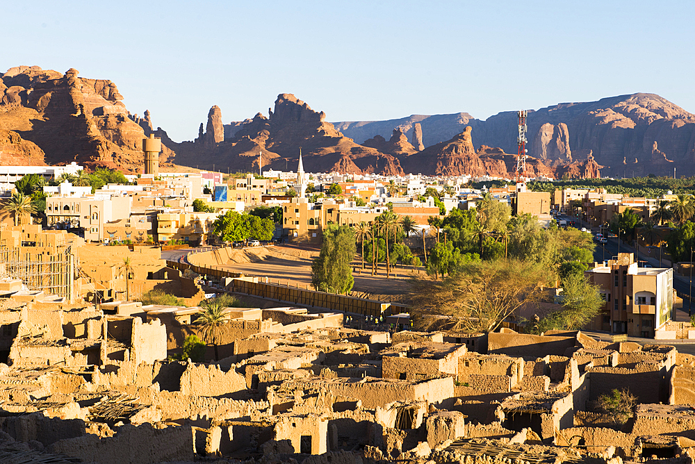 Old mudbrick village under reconstruction with new neighborhoods in the background, in the Old town of AlUla, Medina Province, Saudi Arabia, Middle East