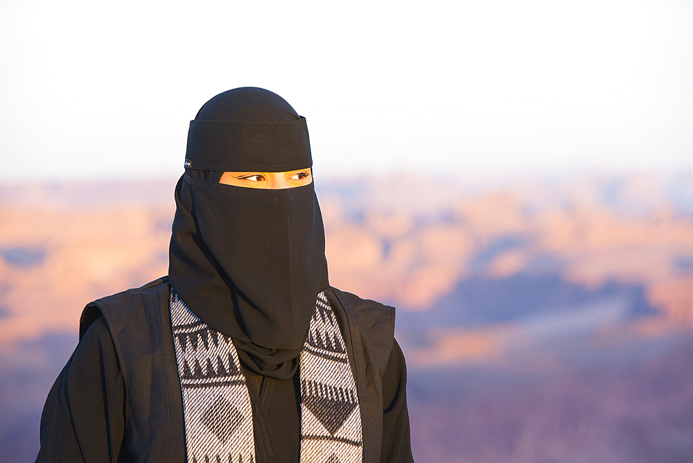 Woman responsible for ensuring the safety and good behavior of visitors at the Viewpoint on the Harrat volcanic plateau, AlUla, Medina Province, Saudi Arabia, Middle East