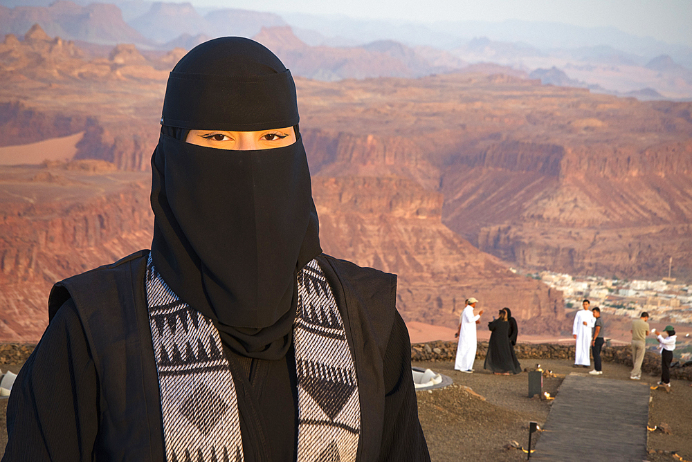 Woman responsible for ensuring the safety and good behavior of visitors at the Viewpoint on the Harrat volcanic plateau, AlUla, Medina Province, Saudi Arabia, Middle East