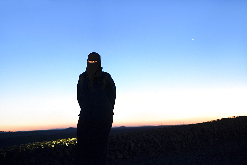 Woman responsible for ensuring the safety and good behavior of visitors at the Viewpoint on the Harrat volcanic plateau, AlUla, Medina Province, Saudi Arabia, Middle East