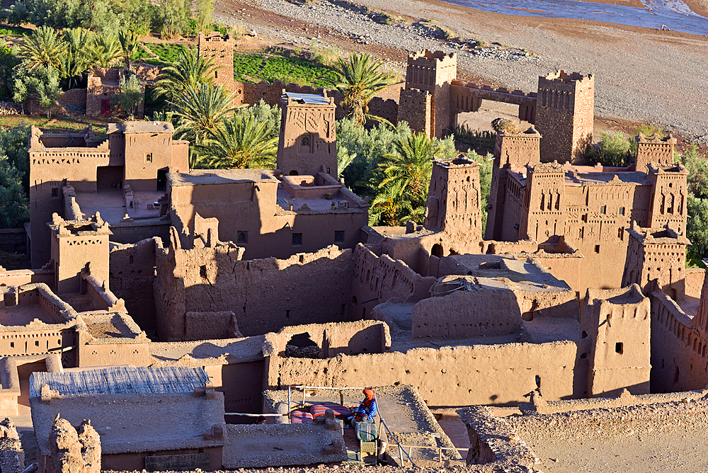 People sitting on the terrace of a cafe overlooking the Ksar of Ait-Ben-Haddou, Ounila River valley, Ouarzazate Province, region of Draa-Tafilalet, Morocco, North West Africa